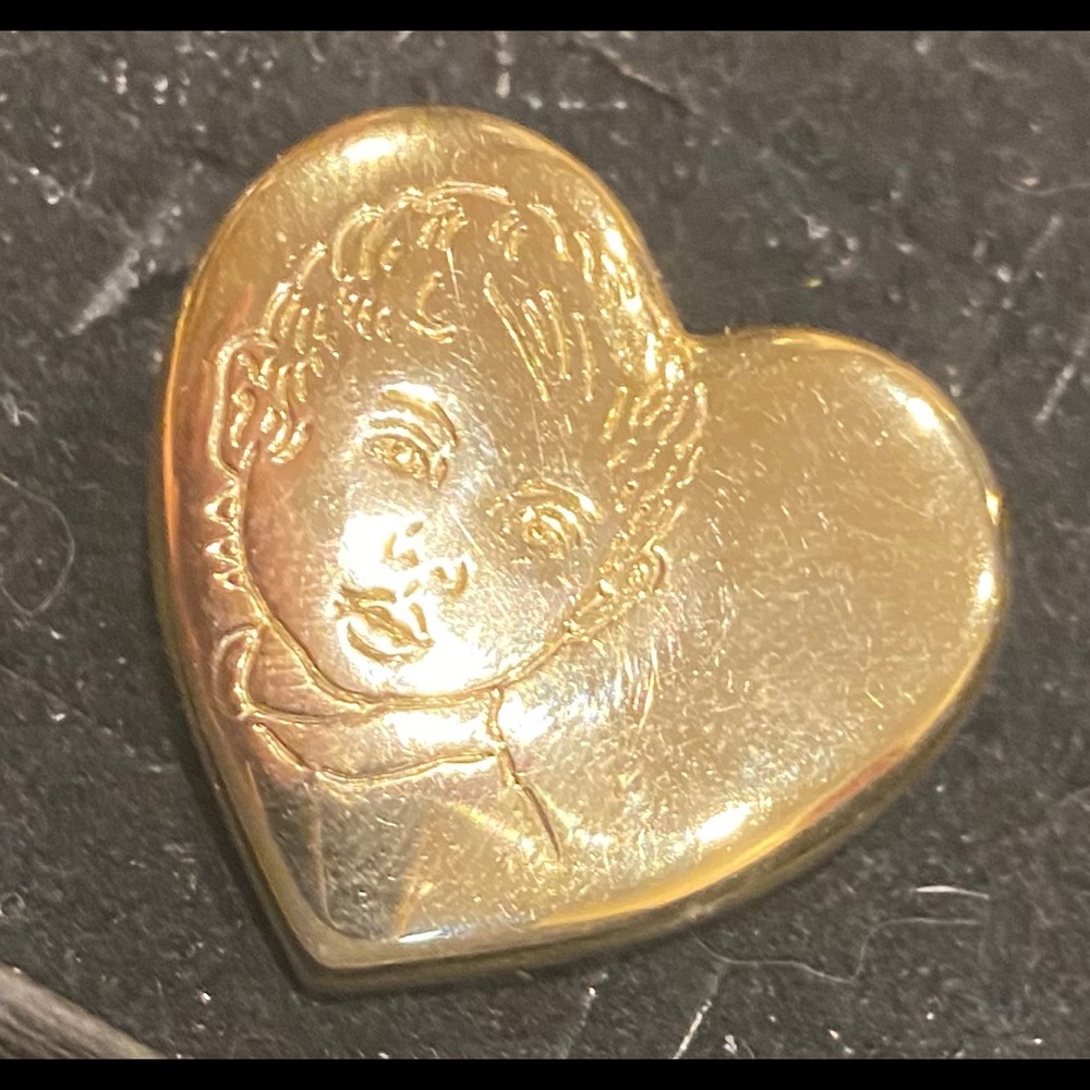 Gold colored brooch with child portrait design
